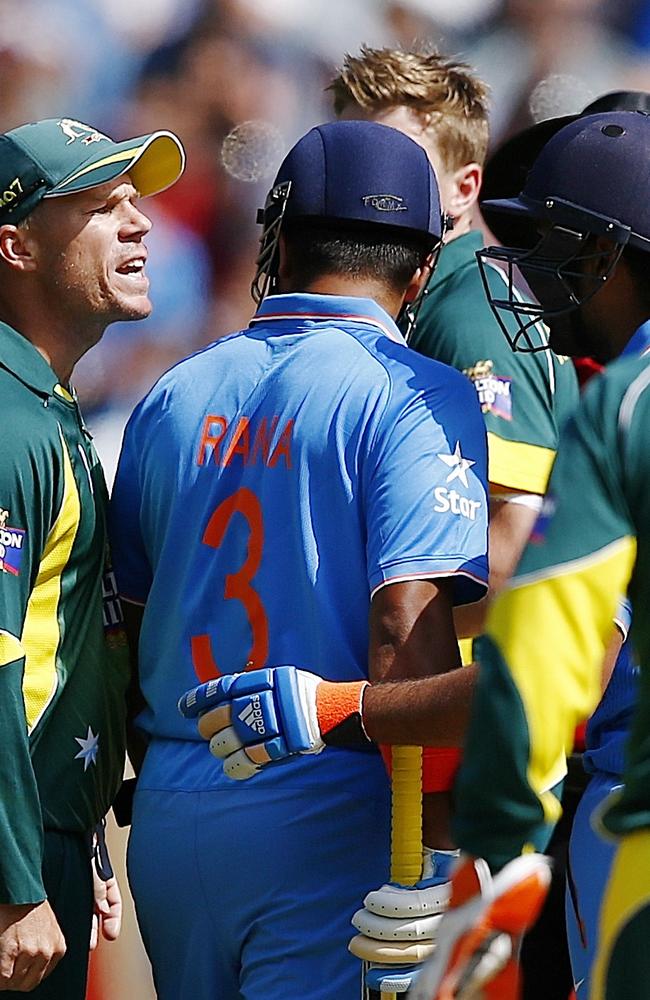 Warner and Sharma exchange pleasantries.