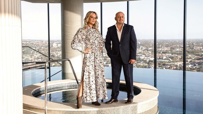 Larry Kestelman with his partner Anita Pahor atop the Captial Grand building. Picture: Nic Walker