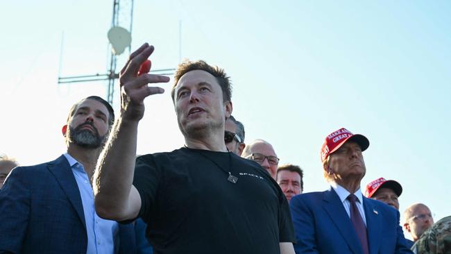 Elon Musk speaks with guests including Donald Trump Jr and US president-elect Donald Trump at a viewing of the launch of the sixth test flight of the SpaceX Starship rocket this week. Picture: Brandon Bell/Getty Images/AFP