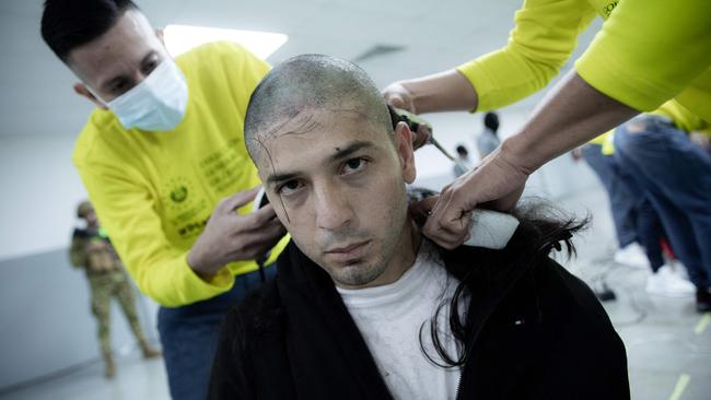 A deportee has his head shaved on arrival in El Salvador. Picture: El Salvador’s Presidency Press Office / AFP