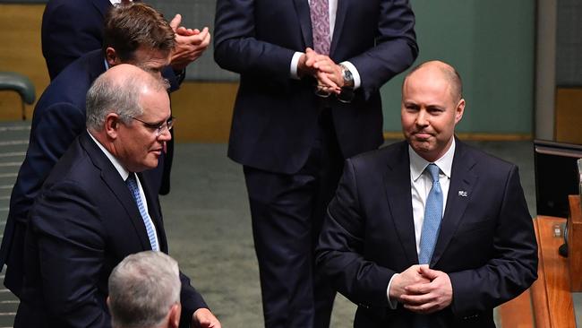 Prime Minister Scott Morrison and Treasurer Josh Frydenberg react after the delivery of the 2020 federal budget in the House of Representatives last night. Picture: Getty Images