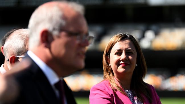 BRISBANE, AUSTRALIA - NewsWire Photos - MARCH 21, 2022.Prime Minister Scott Morrison (centre) watched by Queensland Premier Annastacia Palaszczuk during a visit to the Gabba Stadium in Brisbane to announce the SEQ City Deal.Picture: NCA NewsWire / Dan Peled