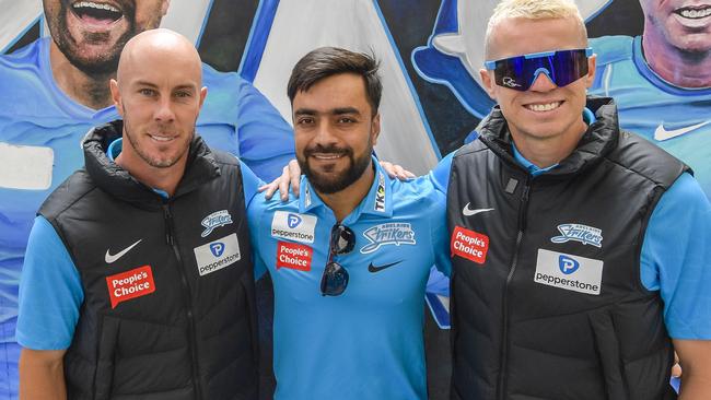 Tuesday  December 13 2022 Adelaide Strikers stars Chris Lynn, Rashid Khan, and Peter Siddle, in front of a Strikers mural in the Rundle Mall ahead of the team's first game Pic. Roy VanDerVegt