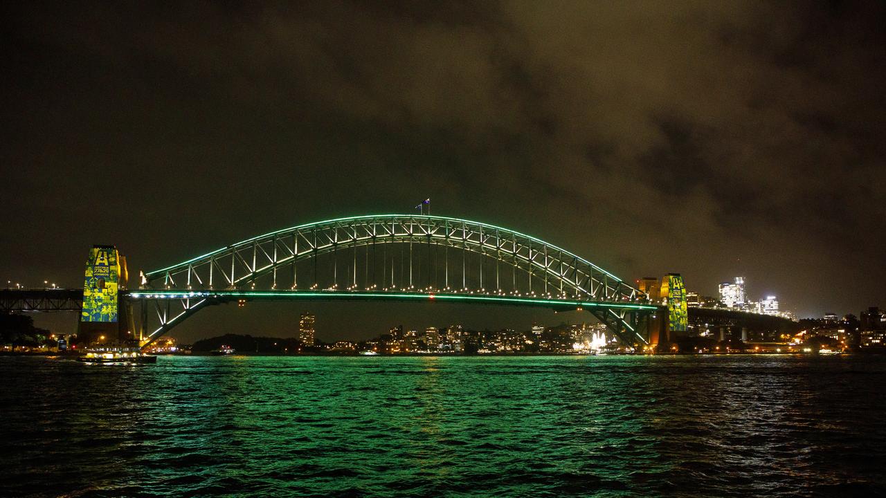 The Sydney Harbour Bridge turns green and gold to celebrate Australia’s successful bid. Picture: Karen Watson.