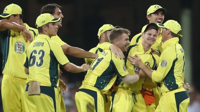 Australia’s fielders celebrate with Steve Smith after his stunning catch.