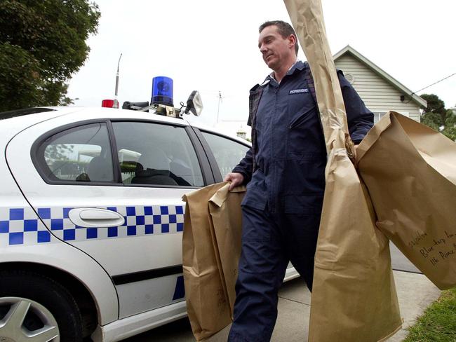 Forensic police take items away from John Sharpe's home in 2004.