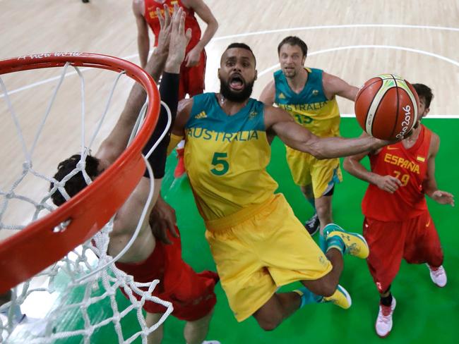 Patty Mills of Australia drives to the basket against Spain.