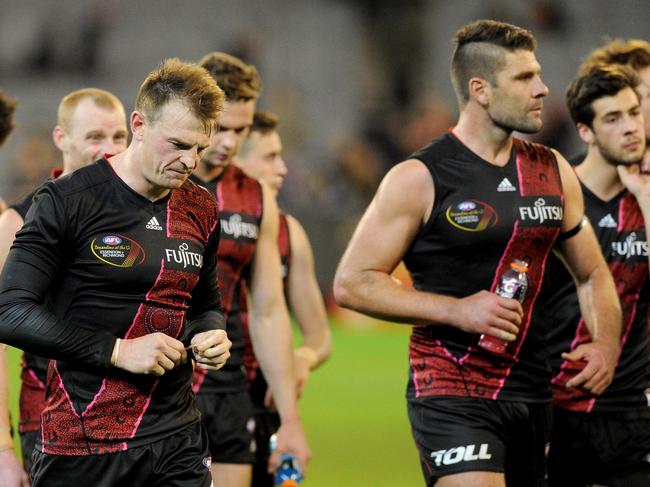 Disappointed Bombers walk off the ground after the side's loss, during the round 10 AFL match between the Essendon Bombers and the Richmond Tigers, played at the MCG in Melbourne, Saturday May 24, 2016.(AAP Image/Joe Castro) NO ARCHIVING