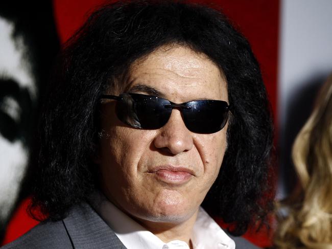 FILE - In this Aug. 23, 2011 file photo, Gene Simmons, left, and Shannon Tweed arrive at the 'Scarface' Legacy Celebration Event in Los Angeles. Rocker Gene Simmons and his longtime girlfriend, actress Shannon Tweed, have tied the knot Saturday Oct. 1, 2011. People magazine reported the couple exchanged vows they wrote themselves. The magazine said about 400 guests attended the Saturday evening ceremony outside a Beverly Hills hotel. (AP Photo/Matt Sayles, file)
