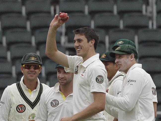 Australia's bowler Pat Cummins, center, with teammates celebrates after dismissing South Africa's batsman Vernon Philander, unseen, for 23 runs on the fourth day of the second test cricket match at the Wanderers stadium in Johannesburg, South Africa, Sunday, Nov. 20, 2011. (AP Photo/ Themba Hadebe)