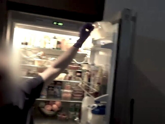 Police searching through John Ibrahim’s fridge.