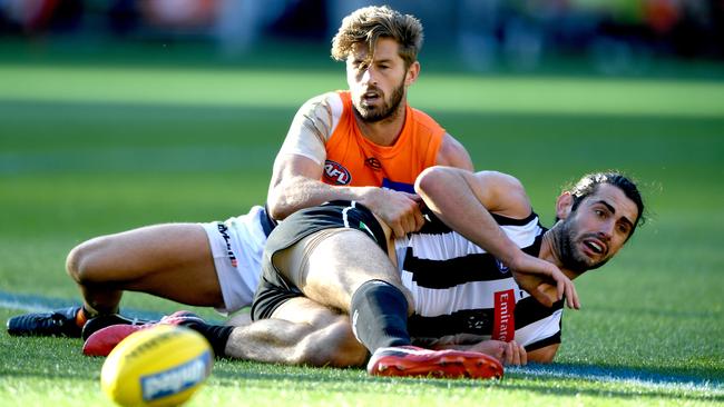 Callan Ward tackles Brodie Grundy.