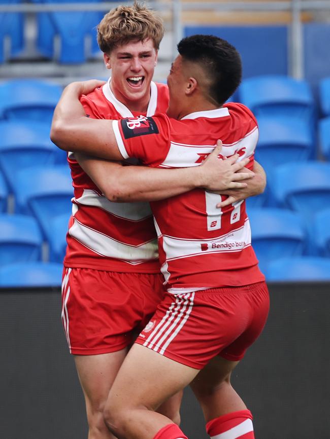 NRL National Schoolboys Cup final at CBUS Stadium between Palm Beach Currumbin and Patrician Blacktown Brothers. The Red Army and Palm Beach Currumbin 's Beau Hartmann scores the winning try and celebrates with team mates.. .Picture Glenn Hampson