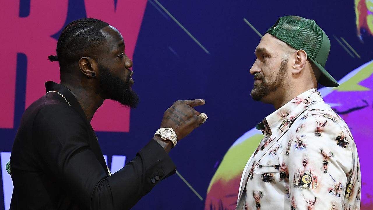 Deontay Wilder and Tyson Fury get together during a news conference.