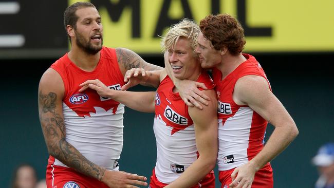 Lance Franklin, Isaac Heeney and Gary Rohan celebrate a Sydney goal.