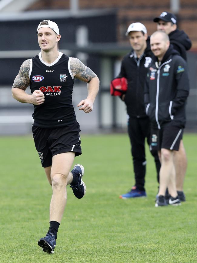 Port Adelaide staff keep a close eye on Hartlett as he returns to running at Alberton Oval last August. Picture SARAH REED