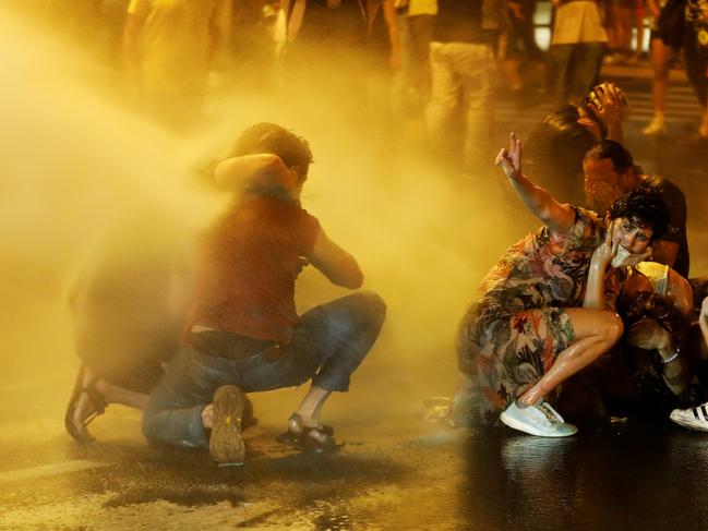 Police use water cannons as they clash with people during a protest against Israeli Prime Minister Benjamin Netanyahu and his government's response to the financial fallout of the coronavirus disease (COVID-19) crisis outside Prime Minister Benjamin Netanyahu's residence in Jerusalem July 15, 2020.  REUTERS/Ronen Zvulun