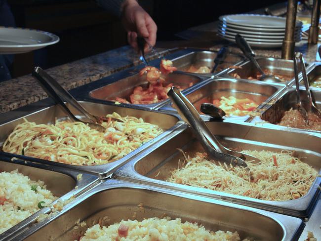 steel trays with food in the canteen of the self-service restaurant. Chinese smorgasbord