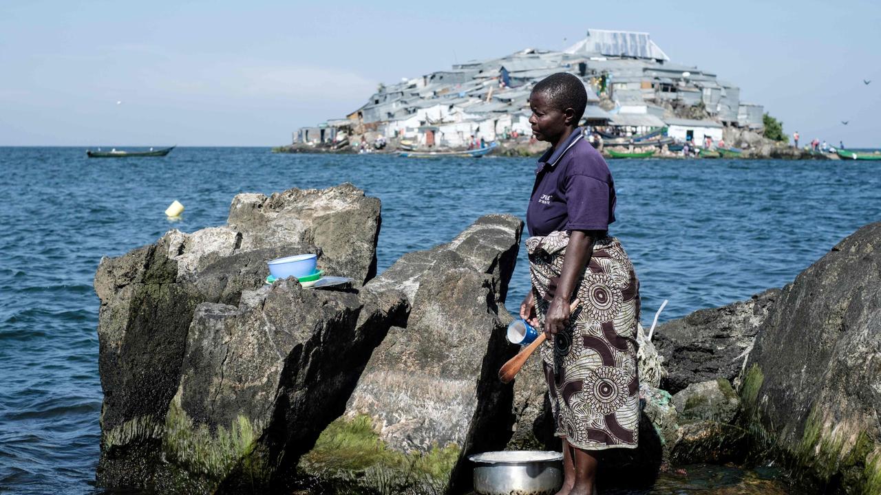 A woman cleans her items on Usingo island next to Migingo island on October 5, 2018. Picture: Yasuyoshi Chiba/AFP