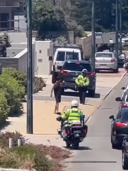 Police can be seen walking after the man. Picture: @browncardigan / Instagram