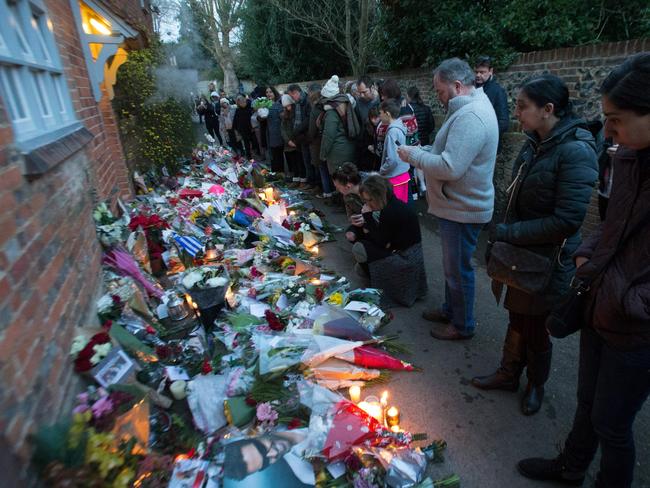 Mourners leave candles, cards and flowers at the Oxfordshire home of British singer George Michael, where he was found dead. Picture: AFP/Daniel Leal-Olivas
