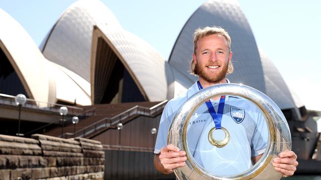 Rhyan Grant poses with the A-League Trophy after scoring the winner for Sydney FC.