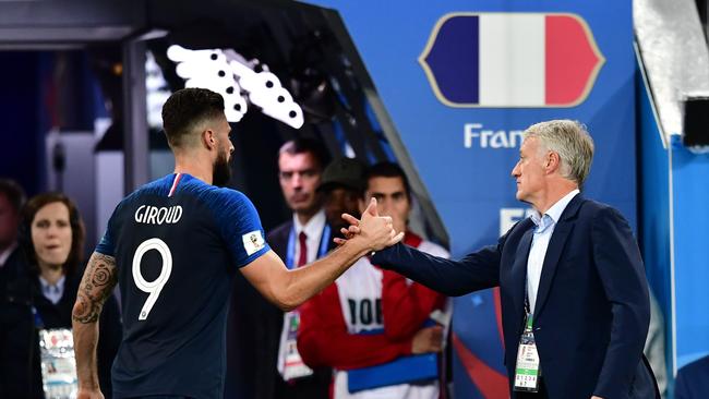 France coach Didier Deschamps (right) greets Olivier Giroud as he leaves the field in the semi-final victory over Belgium. Photo: AFP