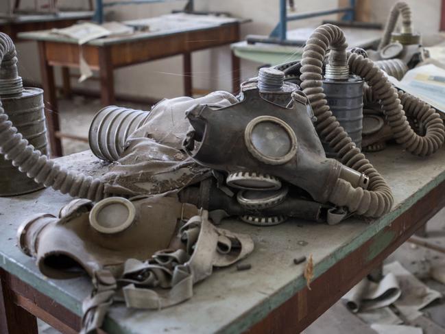 ONE TIME WEB USE ONLY - FEE APPLIES FOR REUSE -  Ukraine: Gas masks left on a school desk. HAUNTING photographs show how nature is reclaiming a town abandoned after a nuclear disaster 33 years ago. A two-year project examining the eerie remains of Chernobyl and Pripyat in Ukraine shows vines snaking around a derelict bumper car, the skeletal remains of a ransacked supermarket, and creepy gasmasks lined up in an old schoolroom. Other fascinating shots show a forsaken potted plant struggling for life in an office block, childrenâ€™s dolls abandoned in a former day care centre, and stacks of papers in a remote post office that havenâ€™t been touched in decades. Dutch photographer Erwin Zwaan, 47, travelled to the 18-mile exclusion zone around Chernobyl in Northern Ukraine in 2016 and 2018 to photograph the ghostly ruins. Mediadrumimages / Erwin Zwaan  Picture: Erwin Zwaan / Media Drum World / australscope