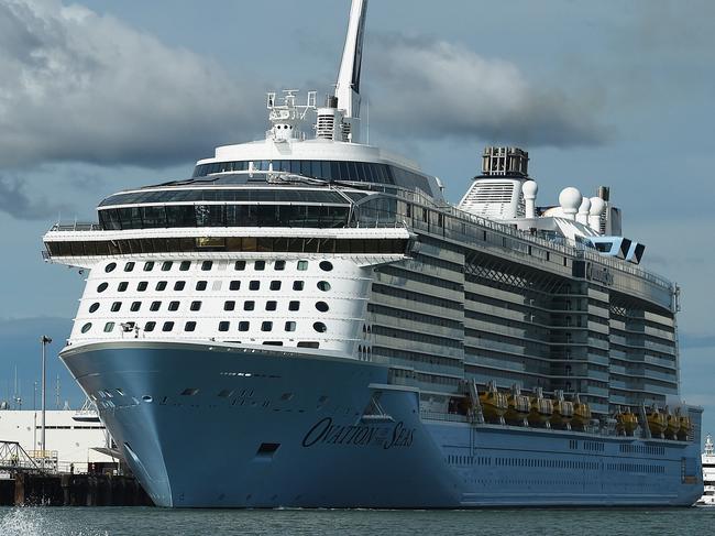 A local boater sees off the massive Ovation of the Seas cruise ship during its departure late Tuesday afternoon after being docked for the day in Darwin before heading to Malaysia.