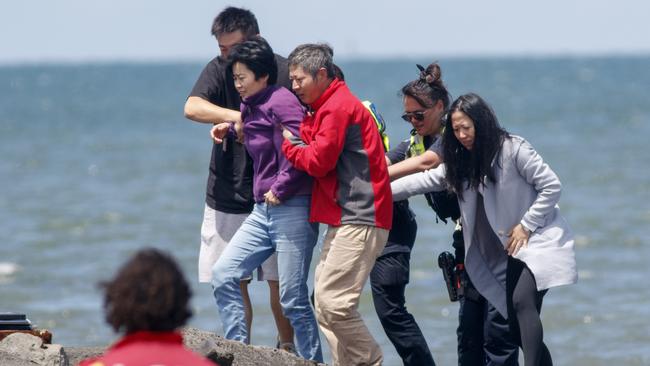 The woman’s family wait on Altona beach. Picture: David Geraghty