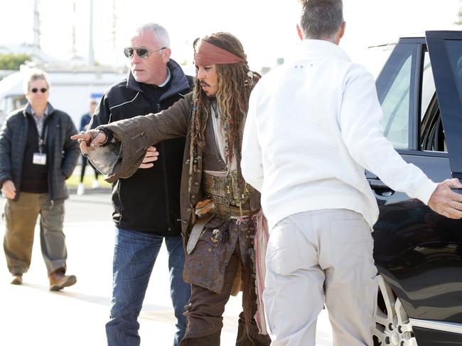 Johnny Depp surrounded by security leaves on a boat to be ferried out to Moreton Bay to continue filming Pirates of the Caribbean. Picture: Liam Kidston