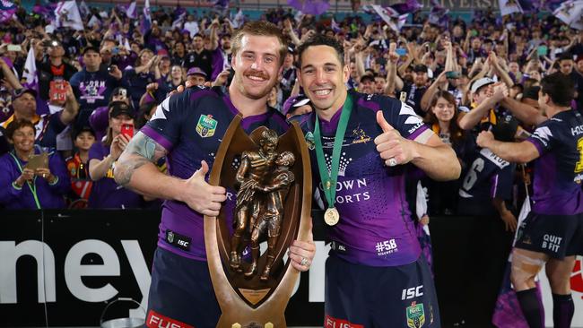 Cameron Munster and Billy Slater celebrate the Storm’s 2017 grand final success.