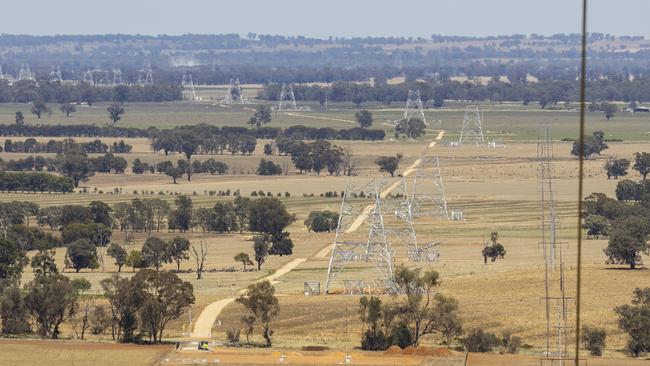 The half-built towers of Project EnergyConnect, Australia’s largest transmission project, cross through cropping and grazing land southwest of Wagga Wagga. This is the view from Mr Petersen’s property near Uranquinty. Picture: Ash Smith