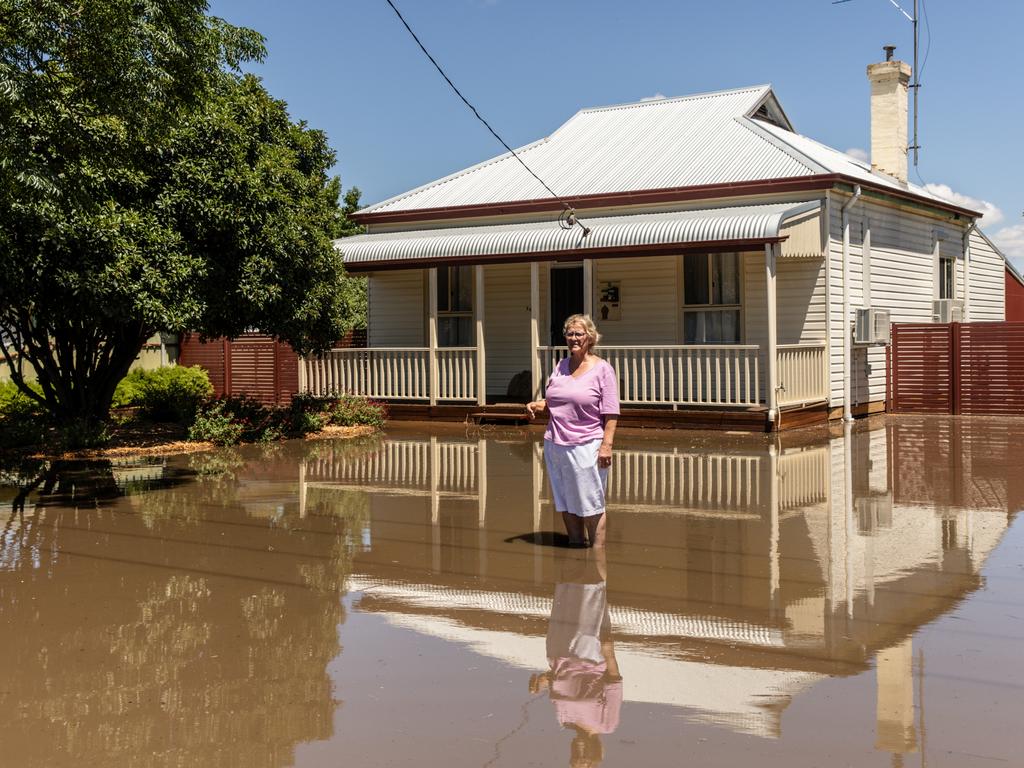 A Rochester local stands by her home as central Victoria faced severe weather warnings, with evacuation alerts following heavy rains. Picture: Diego Fedele/Getty Images