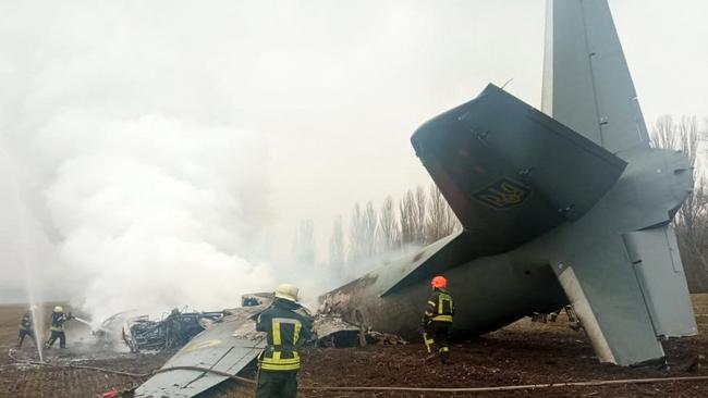 Emergency personnel work at the crash site of a Ukrainian military plane south of Kyiv on February 24.