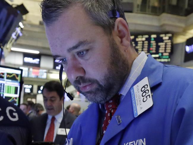 Trader Kevin Lodewick, center, works on the floor of the New York Stock Exchange, Monday, Nov. 2, 2015. Stocks opened slightly higher on Wall Street as the market comes off its biggest monthly gain in four years. Health care stocks were among the early winners. (AP Photo/Richard Drew)