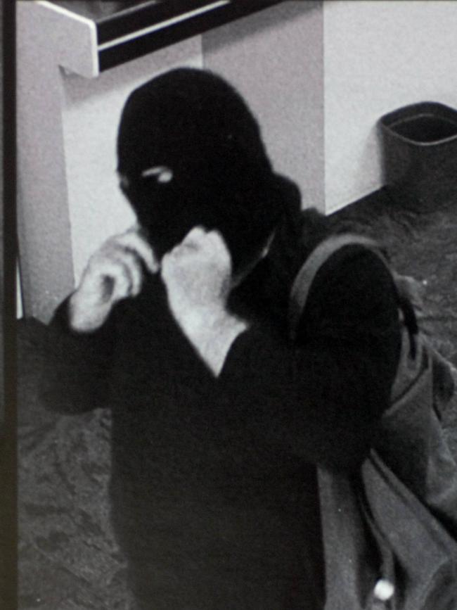 The notorious Adelaide Hills bank robbing bicycle bandit, wearing a balaclava and carrying a gun, captured on security cameras.