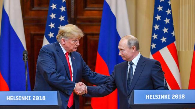 US President Donald Trump (L) and Russia's President Vladimir Putin shake hands before attending a joint press conference after a meeting at the Presidential Palace in Helsinki, on July 16, 2018. The US and Russian leaders opened an historic summit in Helsinki, with Donald Trump promising an "extraordinary relationship" and Vladimir Putin saying it was high time to thrash out disputes around the world. / AFP PHOTO / Yuri KADOBNOV