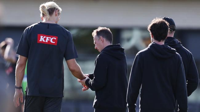 A club doctor checks out Darcy Moore’s wrist on Monday at training. Picture: Picture: Michael Klein