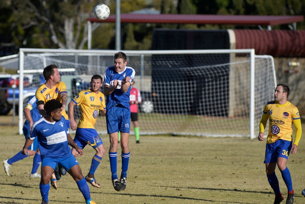 Ashley Freier (left) of USQ FC and James Thompson of Rockville challenge for the ball in Toowoomba Football League Premier Men round 14 at Captain Cook Reserve Des McGovern oval, Sunday, June 24, 2018. Picture: Kevin Farmer