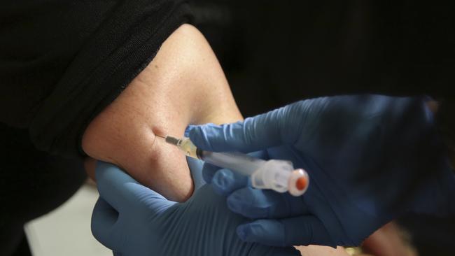 A woman receives a measles, mumps and rubella vaccine (AP Photo/Seth Wenig, File)