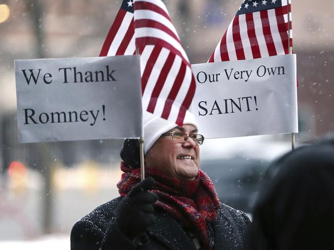 Jay McLeod joins a group of residents gathered at the Wallace F. Bennett Federal Building in Salt Lake City to thank Sen. Mitt Romney for his vote. Picture: AP