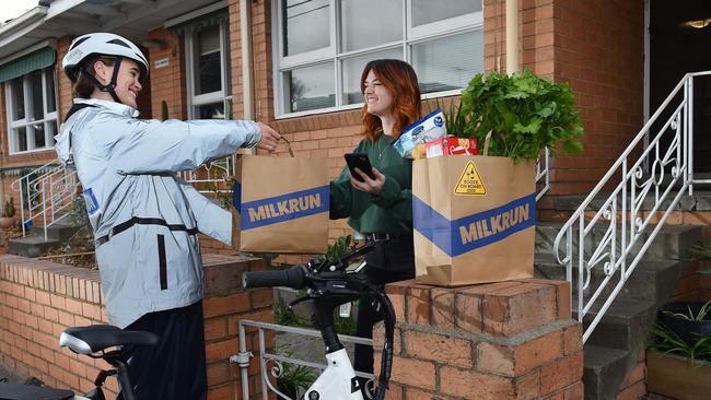 MilkRun delivery service is in the top 50 tech start-ups. MilkRun rider Amy Farnsworth making delivery to Lauren Mason. Picture: Josie Hayden