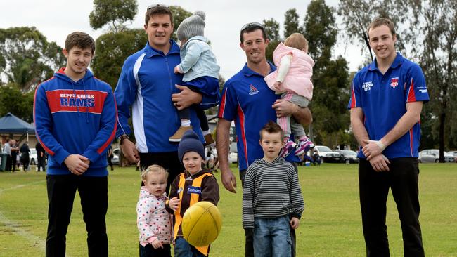 Players Josh Matthews (back left), Brodie Hudson holding daughter Ruby, 2, Mark Boothey holding Ava Muir, 1,  and Ash Benz. Front left, Hannah Brooks, 2, Henry Brooks, 4, and Logan Boothey, 5. Picture: Greg Higgs