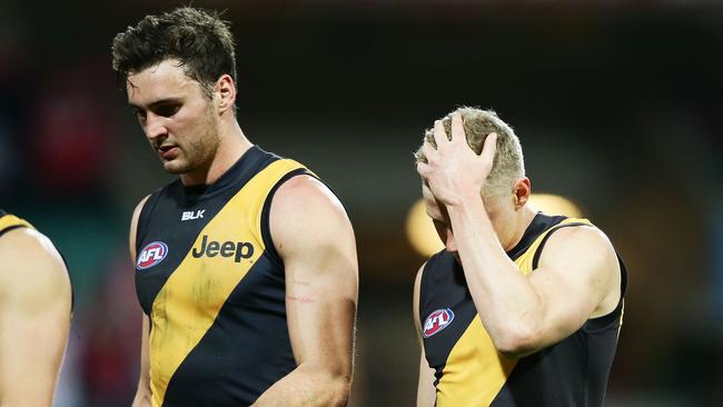 Tigers players look dejected as they leave the field after the loss to Sydney.