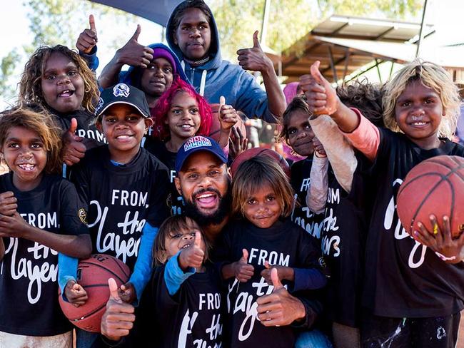 NBA basketballer Patty Mills doing charity work.