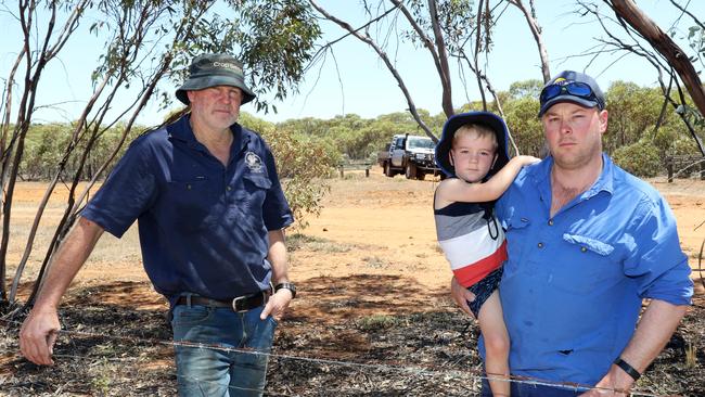 Darren Smith and Ash Jackson, with his son Tim, at Patchewollock on the boundary of Ash's farm and Wyperfield National Park. Picture: Glenn Milne
