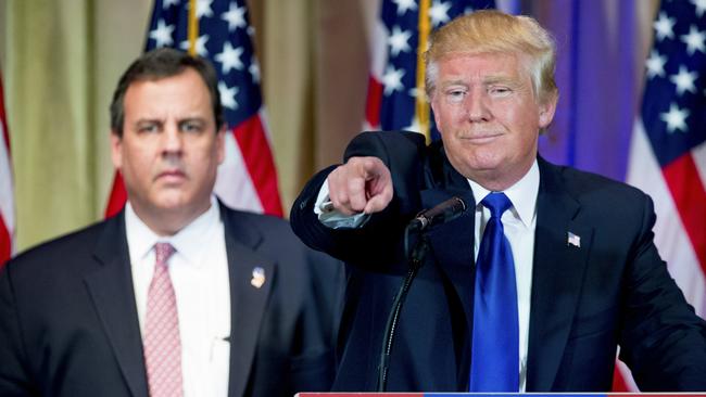 Republican presidential candidate Donald Trump, accompanied by New Jersey Gov. Chris Christie, left, takes questions from members of the media during a news conference on Super Tuesday primary election night in the White and Gold Ballroom at The Mar-A-Lago Club in Palm Beach, Fla., Tuesday, March 1, 2016. (AP Photo/Andrew Harnik)