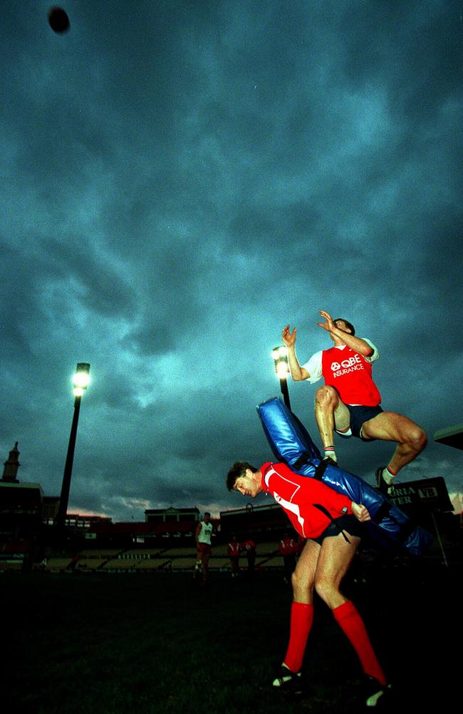 Damian Drum at Sydney training, helping Troy Luff take high marks.