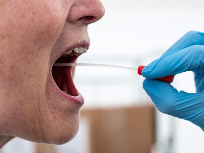 A doctor performs af mouth swab on a patient to test for for Coronavirus Covid-19 in a new tent extension of Danish National Hospital Rigshospitalet in Copenhagen, Denmark, on April 2, 2020. (Photo by Niels Christian Vilmann / Ritzau Scanpix / AFP) / Denmark OUT